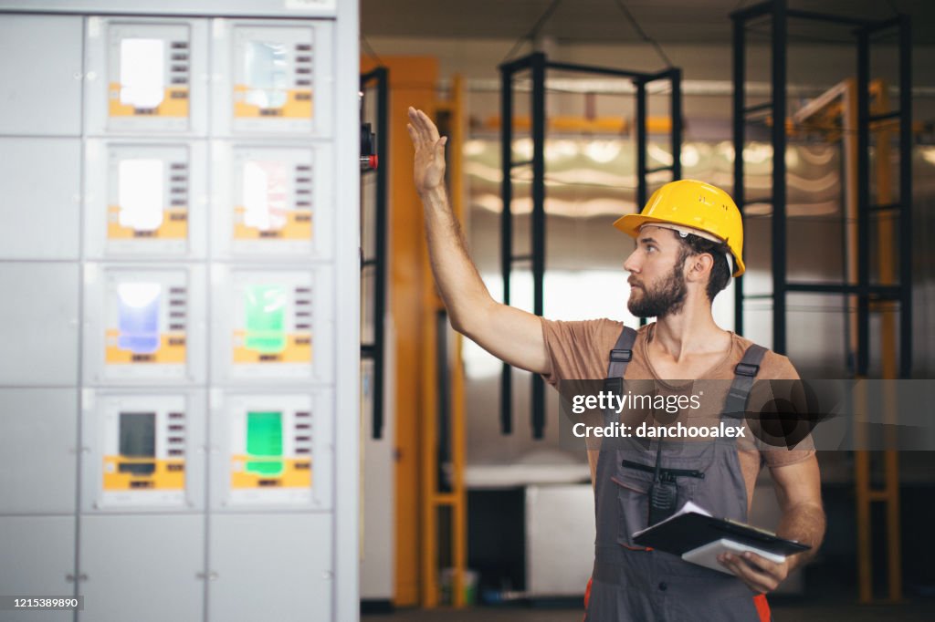 Man Checking Machine Young Man In The Factory Using And Checking Machines High-Res Stock ...