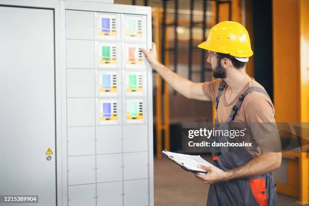 Man Checking Machine Warehouse Pad Photos and Premium High Res Pictures - Getty Images