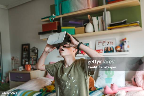 teen boy using vr headset at home - teenager alter stock pictures, royalty-free photos & images