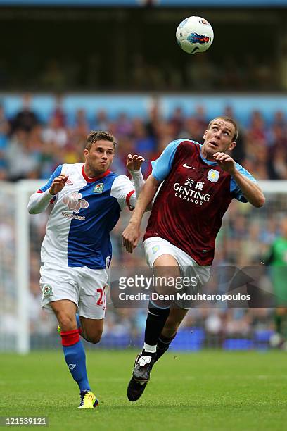 Richard Dunne of Aston Villa battle for the ball with David Goodwillie of Blackburn during the Barclays Premier League match between Aston Villa and...