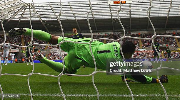 Michael Vorm of Swansea City saves the penalty kick from Ben Watson of Wigan during the Barclays Premier League match between Swansea City and Wigan...