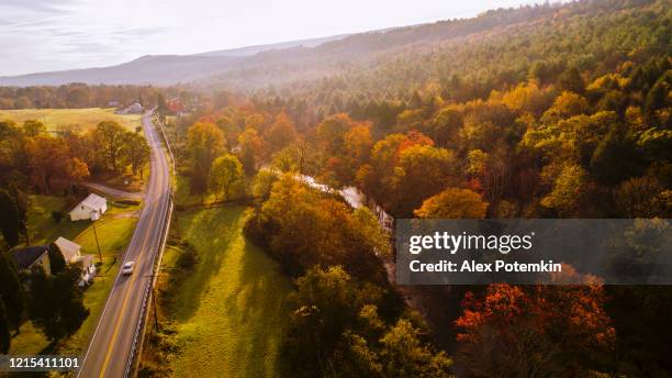 aerial view of the country road in the forest in the mountain in the autumn foggy morning. - montanhas pocono imagens e fotografias de stock