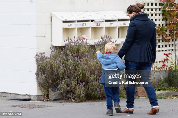 Teddy bear is seen as a boy and his mother, who are the photographer's family, pass by on March 29, 2020 in Christchurch, New Zealand. Inspired by...