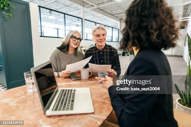 seniors couple having a meeting with financial advisor - retiremen stock pictures, royalty-free photos & images