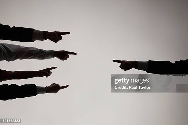 fingers pointing each other - culpabilidad fotografías e imágenes de stock