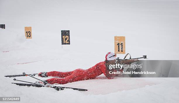man fires biathlon rifle - biathlon ski stock pictures, royalty-free photos & images