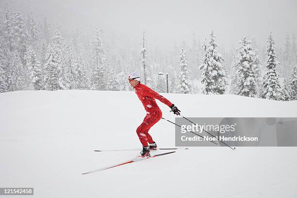 male biathlon competitor cross country skis - langlaufen stock-fotos und bilder