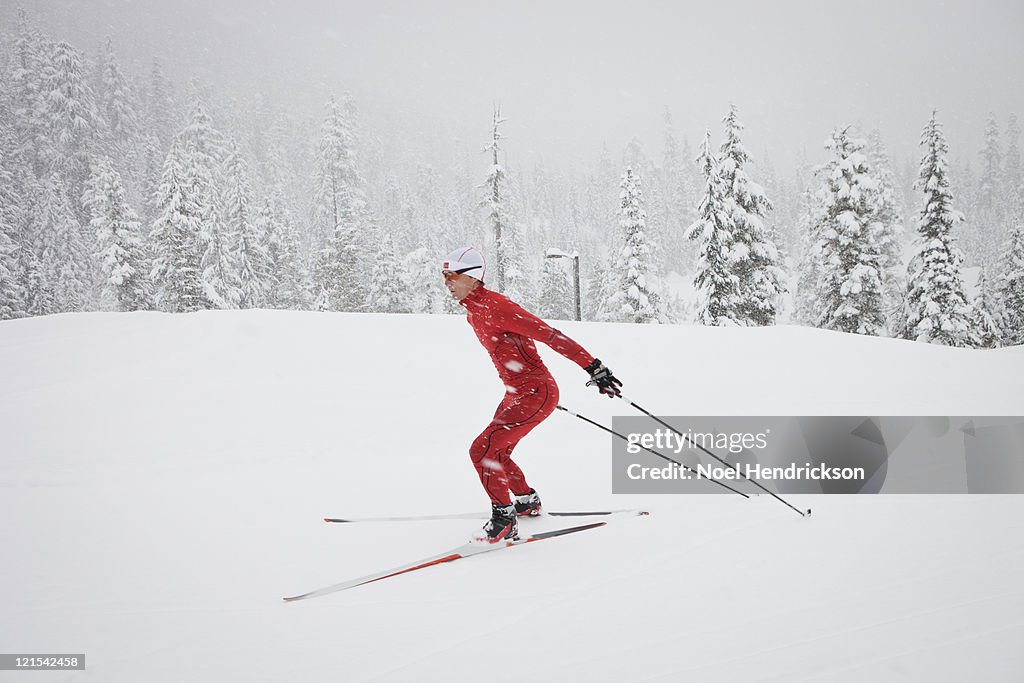 Male biathlon competitor cross country skis