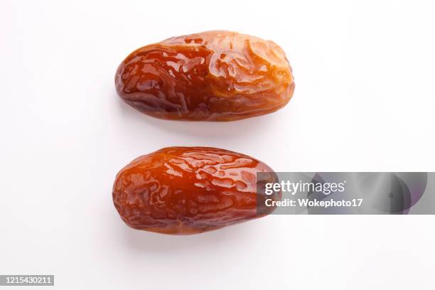 dates fruits on white background - date fruit fotografías e imágenes de stock