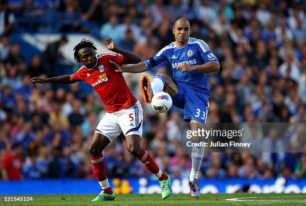 Alex of Chelsea holds off the challenge from Somen Tchoyi of West Brom during the Barclays Premier League match between Chelsea and West Bromwich...