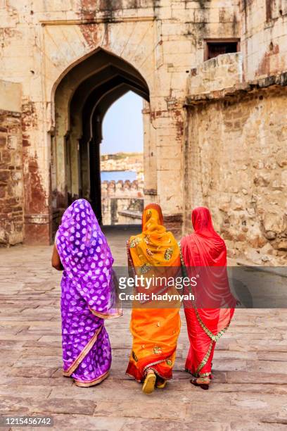three indian women on the way to mehrangarh fort, india - rajasthani women stock pictures, royalty-free photos & images