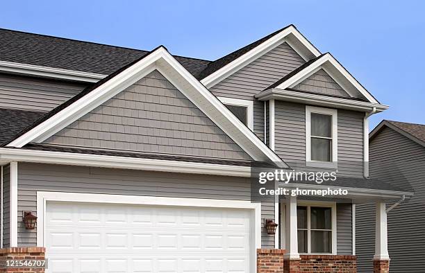 new home construction, showing siding, roofing, gutters, garage door - new home exterior stock pictures, royalty-free photos & images