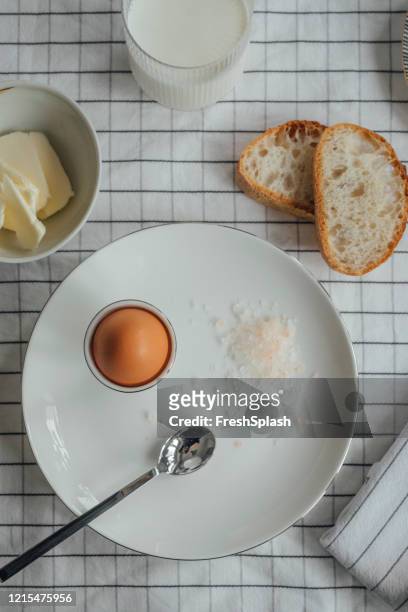 boiled egg with some salt, bread and butter for breakfast - soft boiled egg stock pictures, royalty-free photos & images