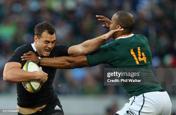 Israel Dagg of the All Blacks is tackled by JP Pietersen of the Springboks during the Tri Nations Test match between the South African Springboks and...