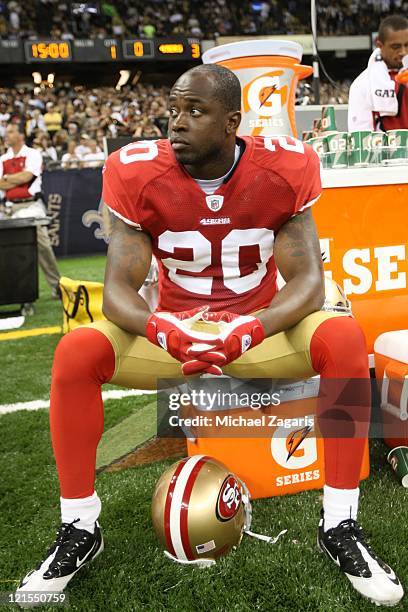 Madieu Williams of the San Francisco 49ers sits on the field prior to the game against the New Orleans Saints at the Louisiana Superdome on August...
