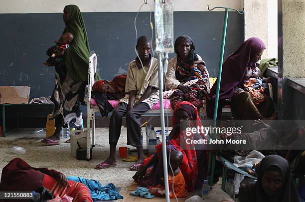 Drought and famine refugees sit in an overflow area of the Banadir hospital on August 20, 2011 in Mogadishu, Somalia. The UN estimates that more than...