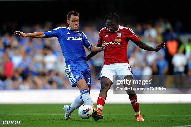 John Terry of Chelsea and Somen Tchoyi of West Brom compete for the ball during the Barclays Premier League match between Chelsea and West Bromwich...