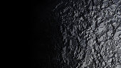Black textured stone coal with a metallic sheen