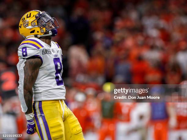 Linebacker Patrick Queen of the LSU Tigers celebrates after making a tackle during the College Football Playoff National Championship game against...