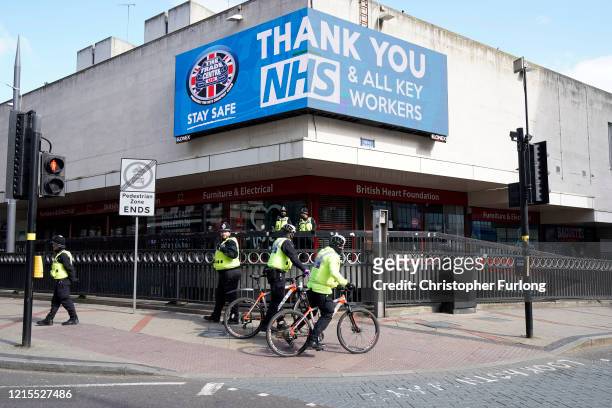 Police officers patrol a deserted Corporation Street in Birmingham city centre during the nationwide lockdown on March 29, 2020 in Birmingham, United...