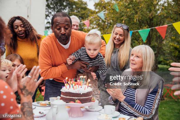 blowing out the candles - senior birthday stock pictures, royalty-free photos & images
