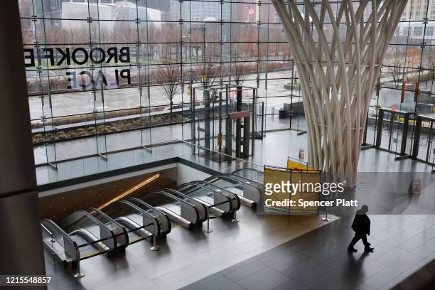 Person exits the subway at an empty Brookfield Place mall in lower Manhattan on March 29, 2020 in New York City. Across the country schools,...