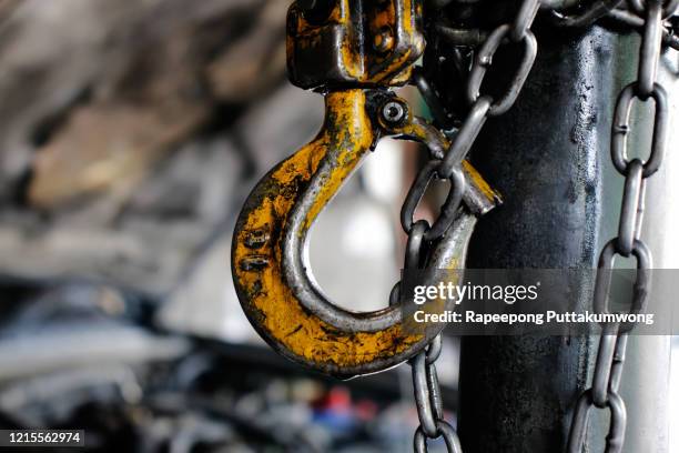 chain hoist. industrial hook hanging on reel chain - crane construction machinery stock pictures, royalty-free photos & images