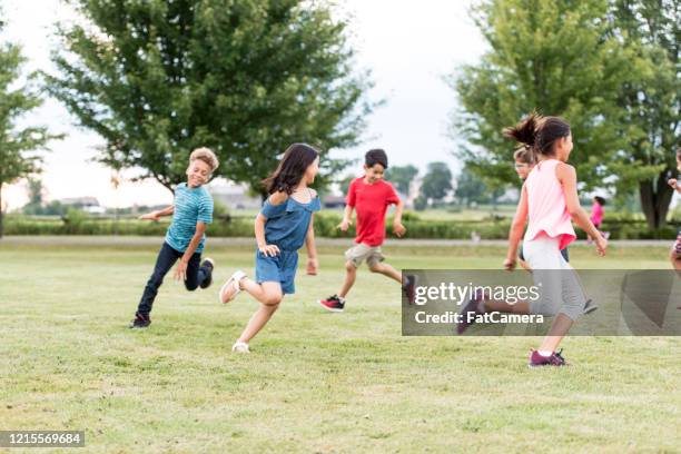 elementary school students play at recess stock photo - kids playing stock pictures, royalty-free photos & images