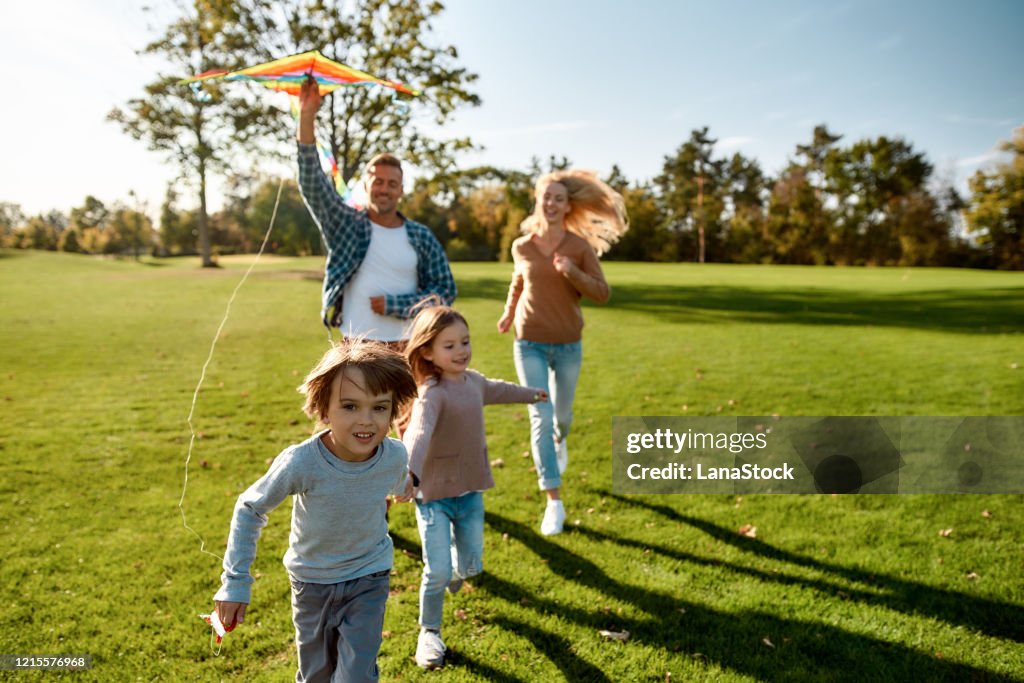 There are no words to describe how special kids are. Happy family playing a kite. Outdoor family weekend