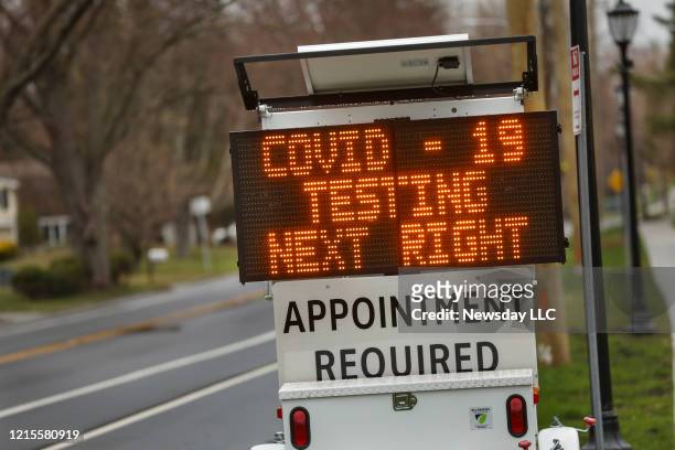 Digital sign on Stony Brook Road in Stony Brook, New York on Long Island directs patients to the drive-thru coronavirus test site at Stony Brook...