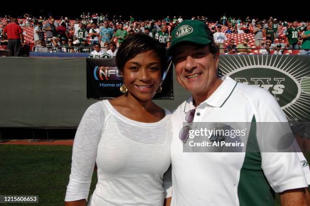 Actor Dan Grimaldi meets with former Olympian Dominique Dawes when they attend the New York Jets vs New England Patriots game at The Meadownlands on...