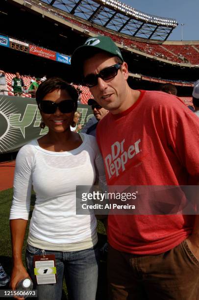 Adam Sandler meets with former Olympian Dominique Dawes when they attend the New York Jets vs New England Patriots game at The Meadownlands on...
