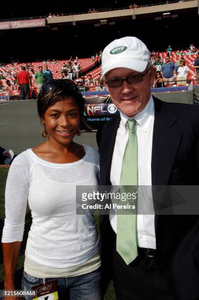 New York Jets Owner Woody Johnson meets with former Olympian Dominique Dawes when they attend the New York Jets vs New England Patriots game at The...