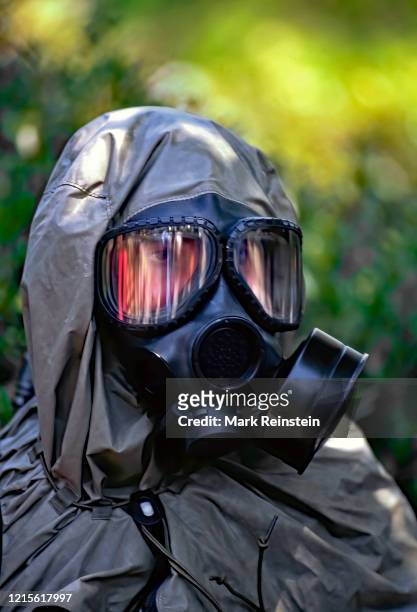 Member of the US Marine Corps Chemical / Biological Incident Response Force wears a chemical /biological protection suit in response to a simulated...