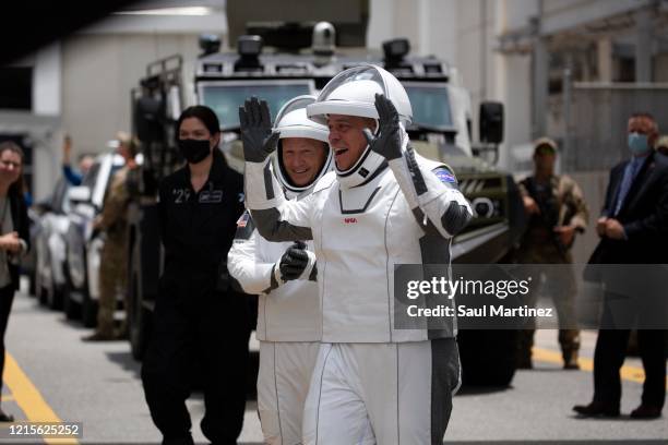 Astronauts Doug Hurley and Bob Behnken wave to their families before boarding at the pre-launch of the SpaceX Falcon 9 rocket with the Crew Dragon...
