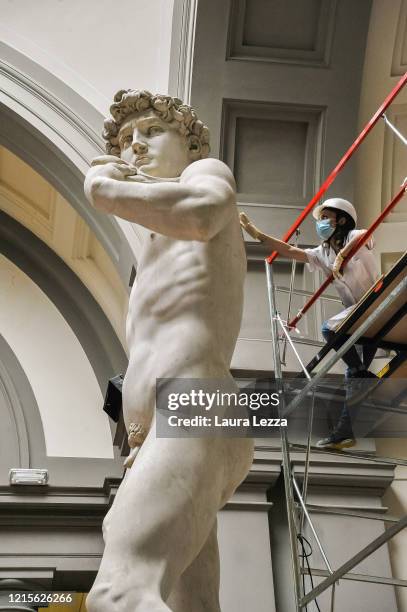 Restorer cleans Michelangelo's David statue while preparing for the reopening of the Galleria dell'Accademia which was closed for almost three months...