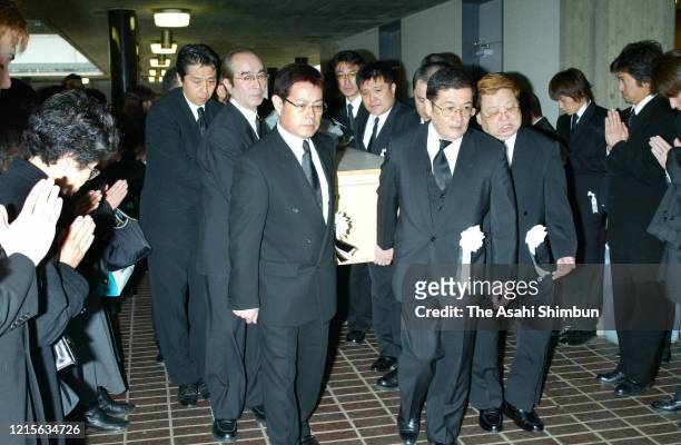 The members of Chosuke Ikariya's comedian group The Drifters, Ken Shimura, Cha Kato, Koji Nakamoto and Bu Takagi hold the coffin at the funeral of...