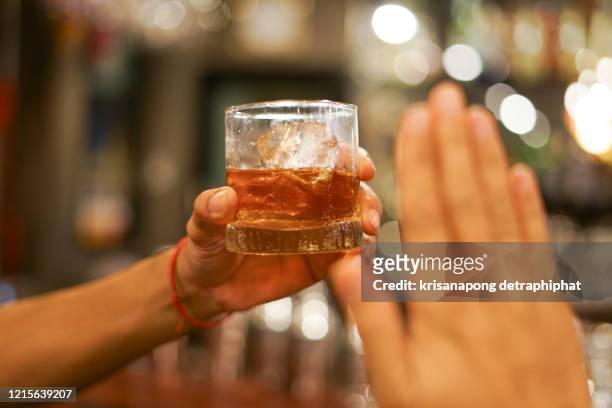 stop drinking,stop drinking conceptman alcoholic social problems sitting at table refusal of alcohol say no to addiction close-up - - geste stop photos et images de collection