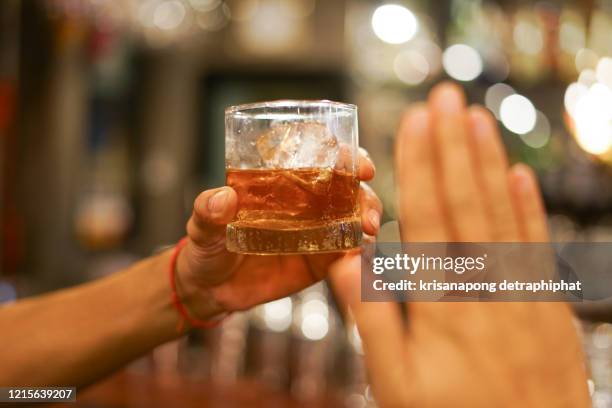 stop drinking,stop drinking conceptman alcoholic social problems sitting at table refusal of alcohol say no to addiction close-up - - stop drinking stock pictures, royalty-free photos & images