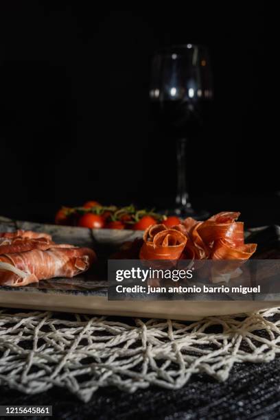 serrano ham and a glass of wine. - spiral ham stock pictures, royalty-free photos & images