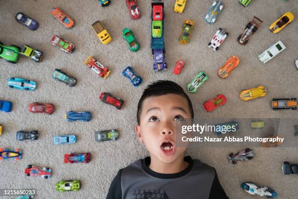 kid at home playing with his cars. - boy toy stockfoto's en -beelden