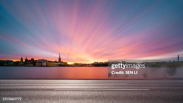 sunrise cityscapes background in stockholm with river and road foreground - stockholm city stock pictures, royalty-free photos & images