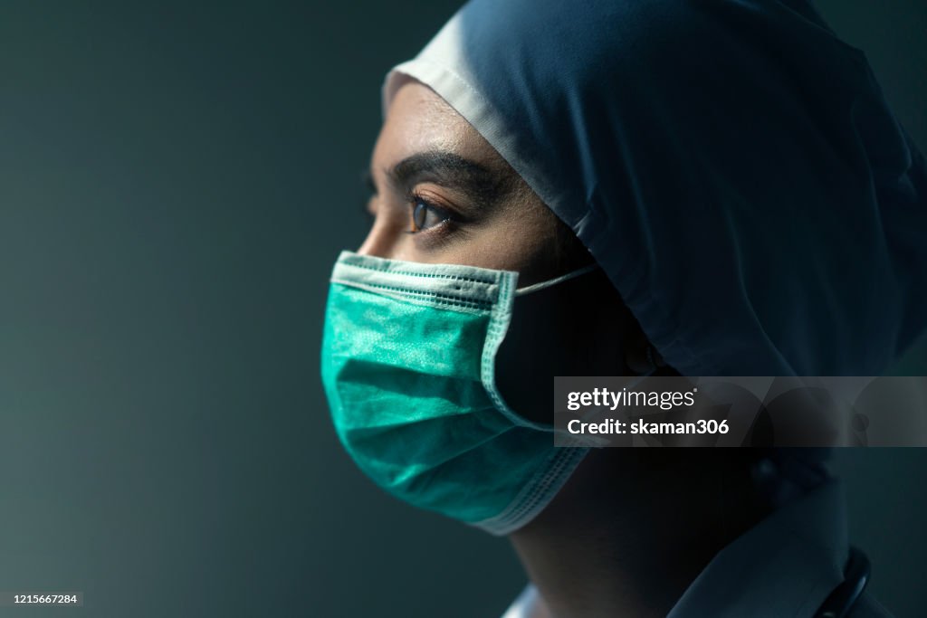 Closeup Asian female Doctor wearing face shield and PPE suit for Coronavirus outbreak or Covid-19, Concept of Covid-19 quarantine
