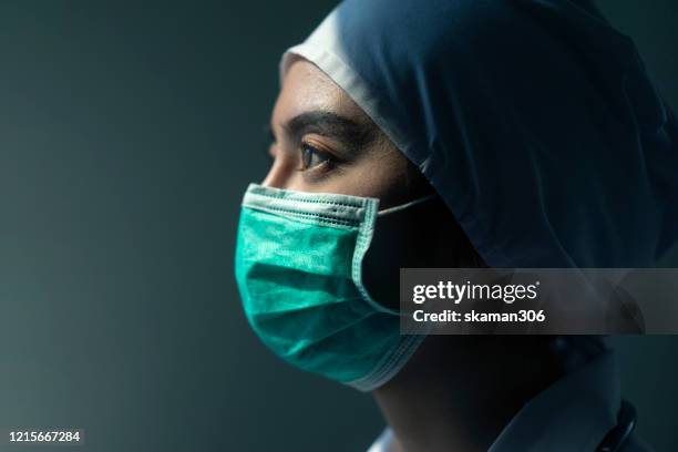 closeup asian female doctor wearing face shield and ppe suit for coronavirus outbreak or covid-19, concept of covid-19 quarantine - scientist portrait stock pictures, royalty-free photos & images