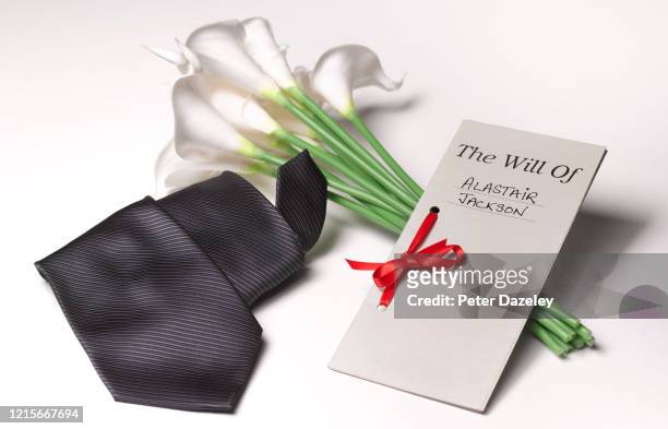 funeral tie, lillies with last will and testament - funeral planning stock pictures, royalty-free photos & images