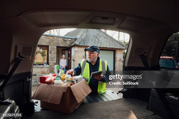 a helping hand - groceries tablet stock pictures, royalty-free photos & images