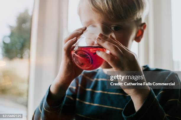 diluted juice - child eating juicy stock pictures, royalty-free photos & images