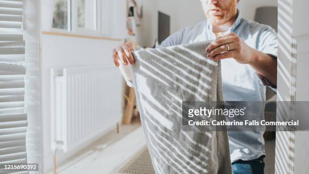 folding laundry - towel stock pictures, royalty-free photos & images