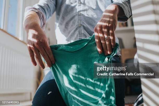folding laundry - garment tag stock pictures, royalty-free photos & images