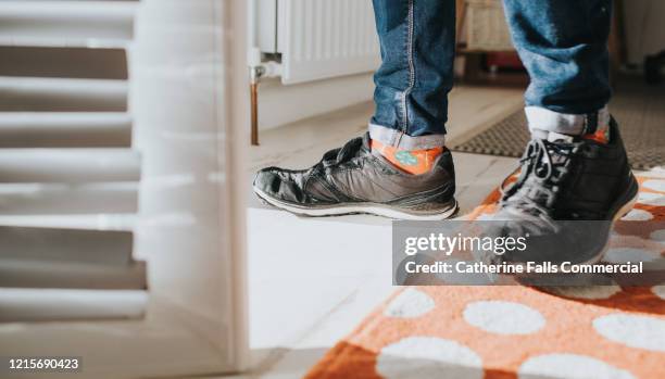 black trainers - man walking feet inside stock pictures, royalty-free photos & images